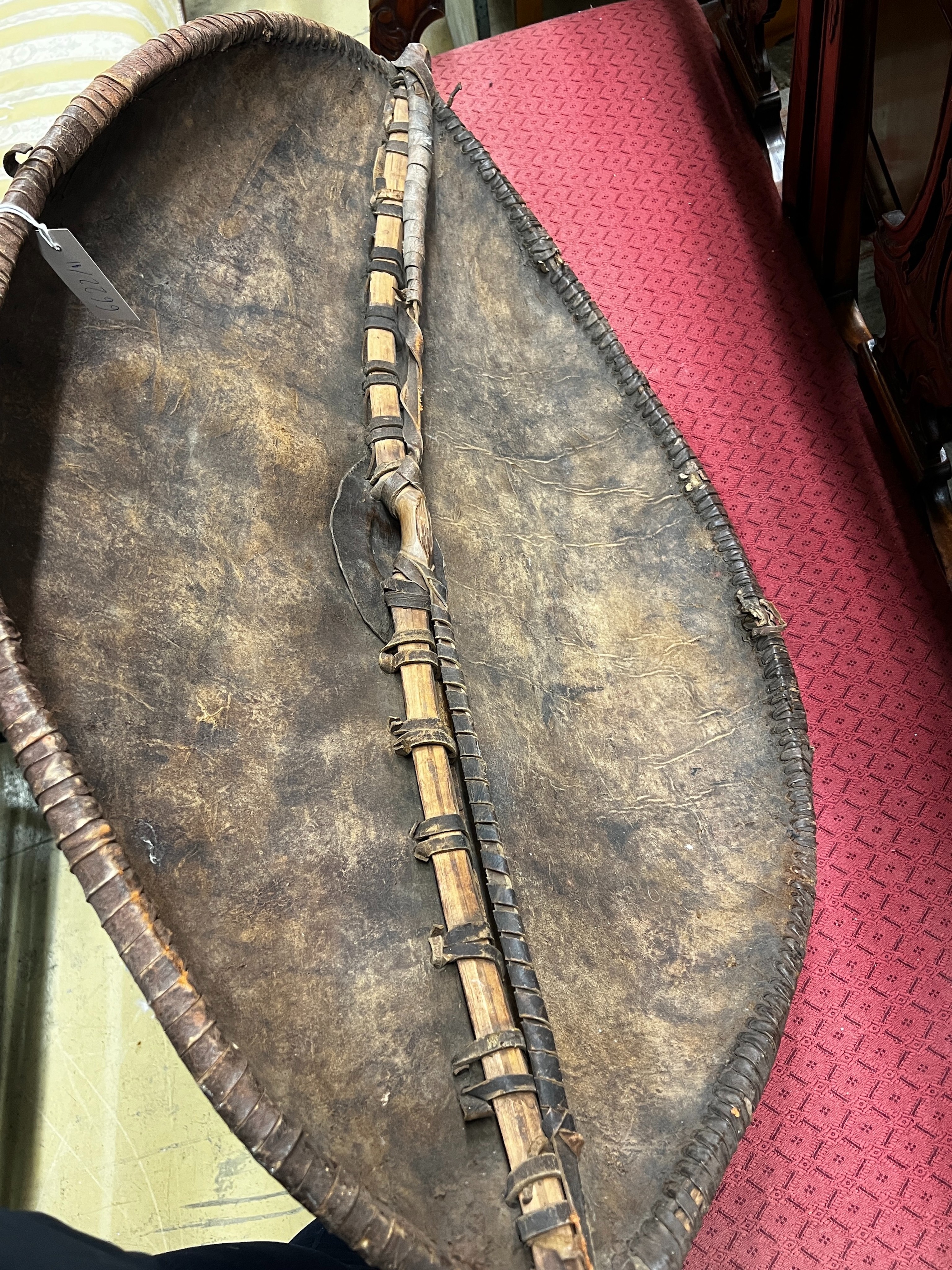 An African painted leather tribal shield, height 102cm